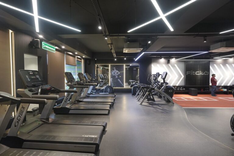 Modern gym with treadmills and training area.